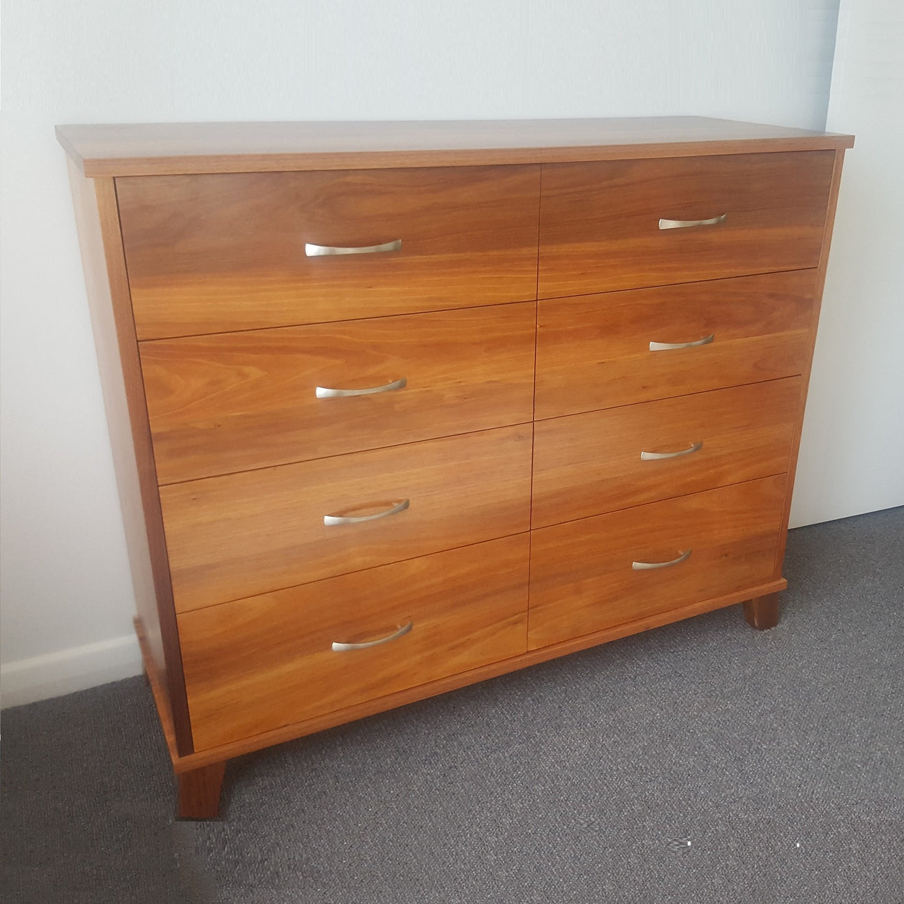 A tall chest of drawers with plenty of storage for clothes and blanket