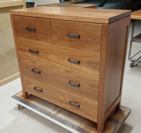 A classic chest of drawers with even drawers and timber knobs Raglan