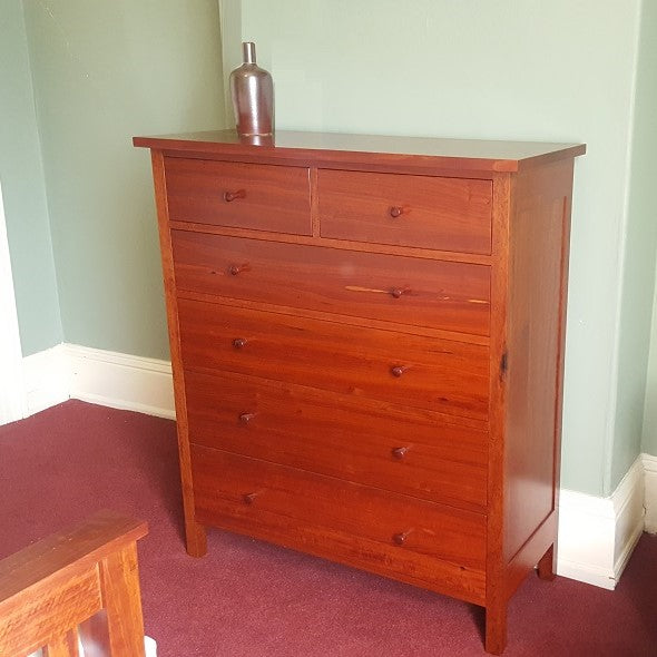 A classic chest of drawers with even drawers and timber knobs Raglan